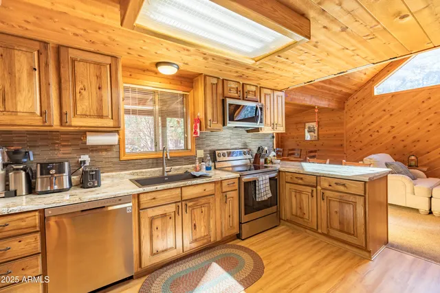 a kitchen with stainless steel appliances granite countertop a sink and cabinets