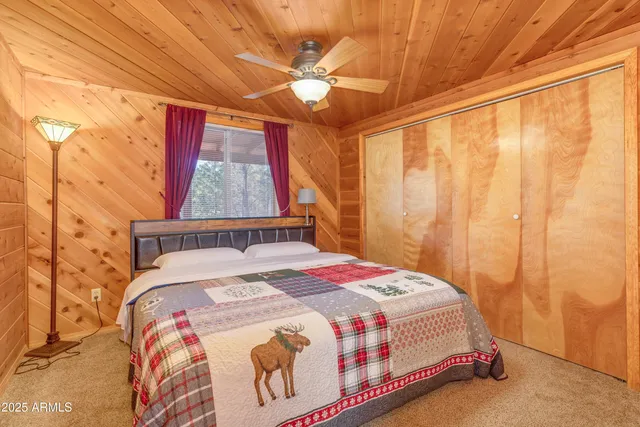 a bedroom with a bed a window and a ceiling fan