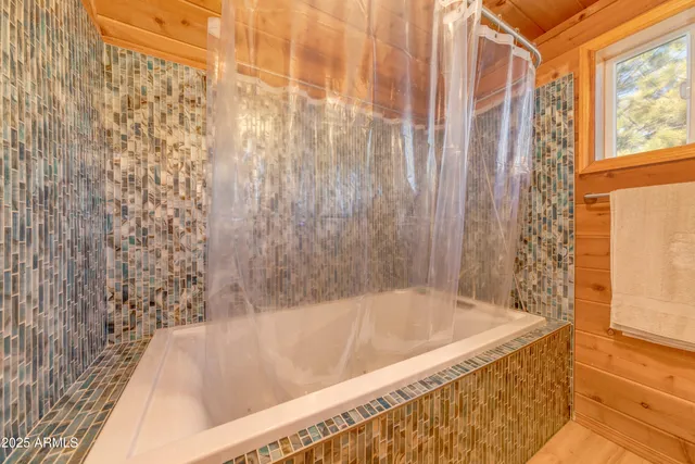 a bath tub sitting next to a shower