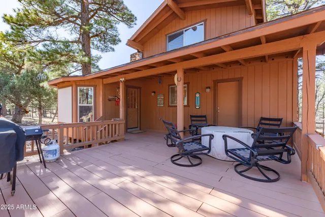 a view of a house with backyard porch and sitting area