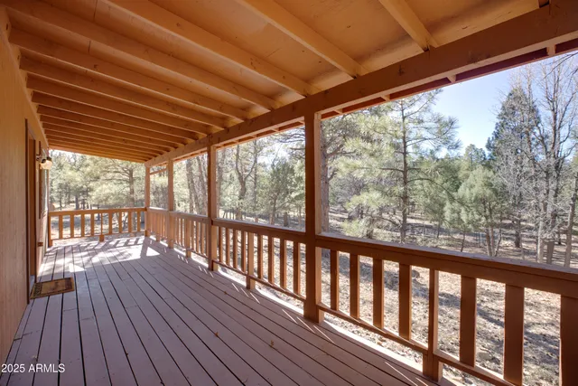 a view of a porch with wooden floor in front of a house