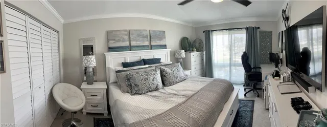 a living room with furniture a flat screen tv and a large window