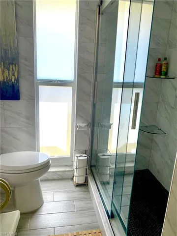 a bathroom with a toilet and a shower