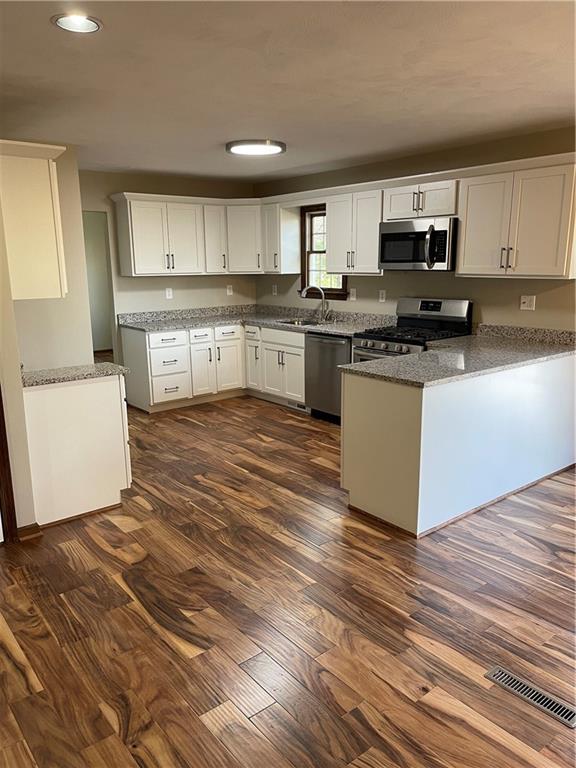 690 Adele Drive North Huntingdon, PA 15642 - Photo 3 of 25 a kitchen with stainless steel appliances granite countertop a stove top oven a sink dishwasher and a refrigerator