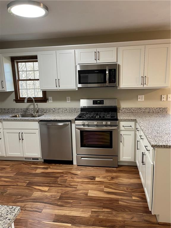 690 Adele Drive North Huntingdon, PA 15642 - Photo 4 of 25 a kitchen with granite countertop a stove and a sink