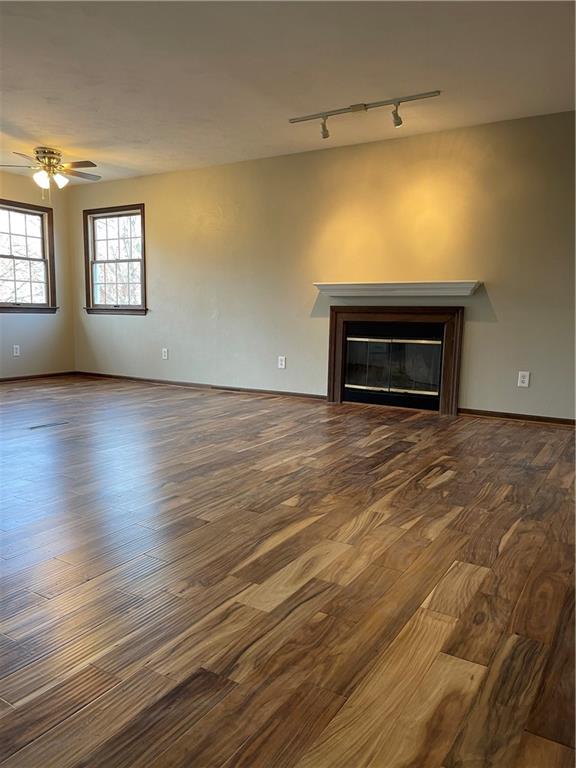 690 Adele Drive North Huntingdon, PA 15642 - Photo 7 of 25 wooden floor fireplace and windows in an empty room