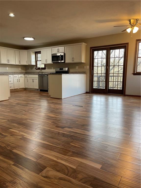 690 Adele Drive North Huntingdon, PA 15642 - Photo 10 of 25 a large kitchen with stainless steel appliances granite countertop a stove and a wooden floors
