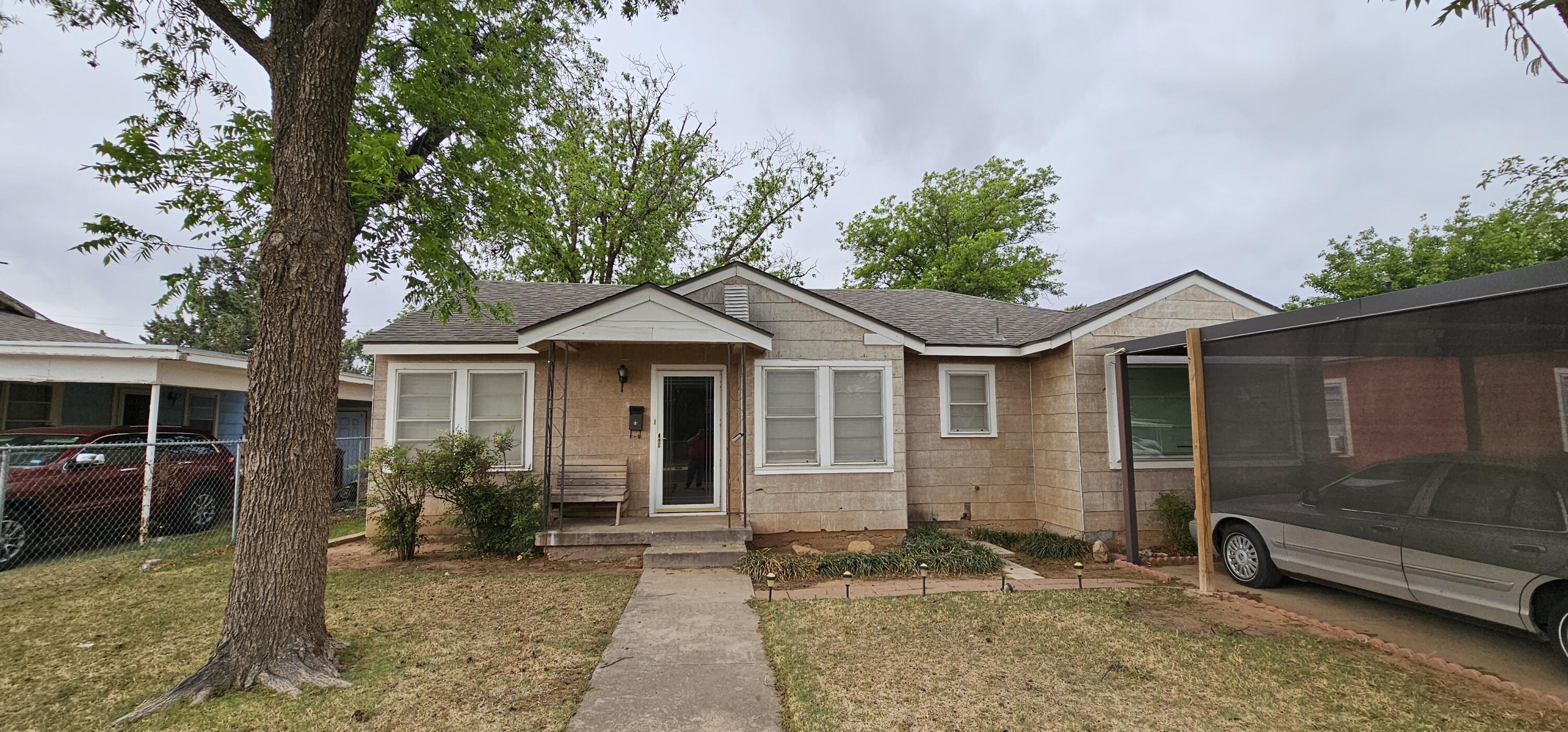 2007 62nd Street Lubbock, TX 79412 - Photo 1 of 17 a front view of a house with garden