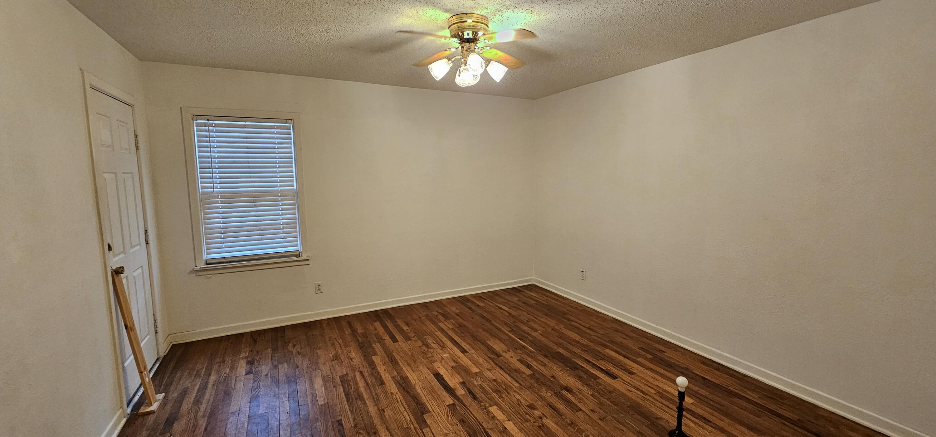 2007 62nd Street Lubbock, TX 79412 - Photo 5 of 17 a view of an empty room with wooden floor and a window
