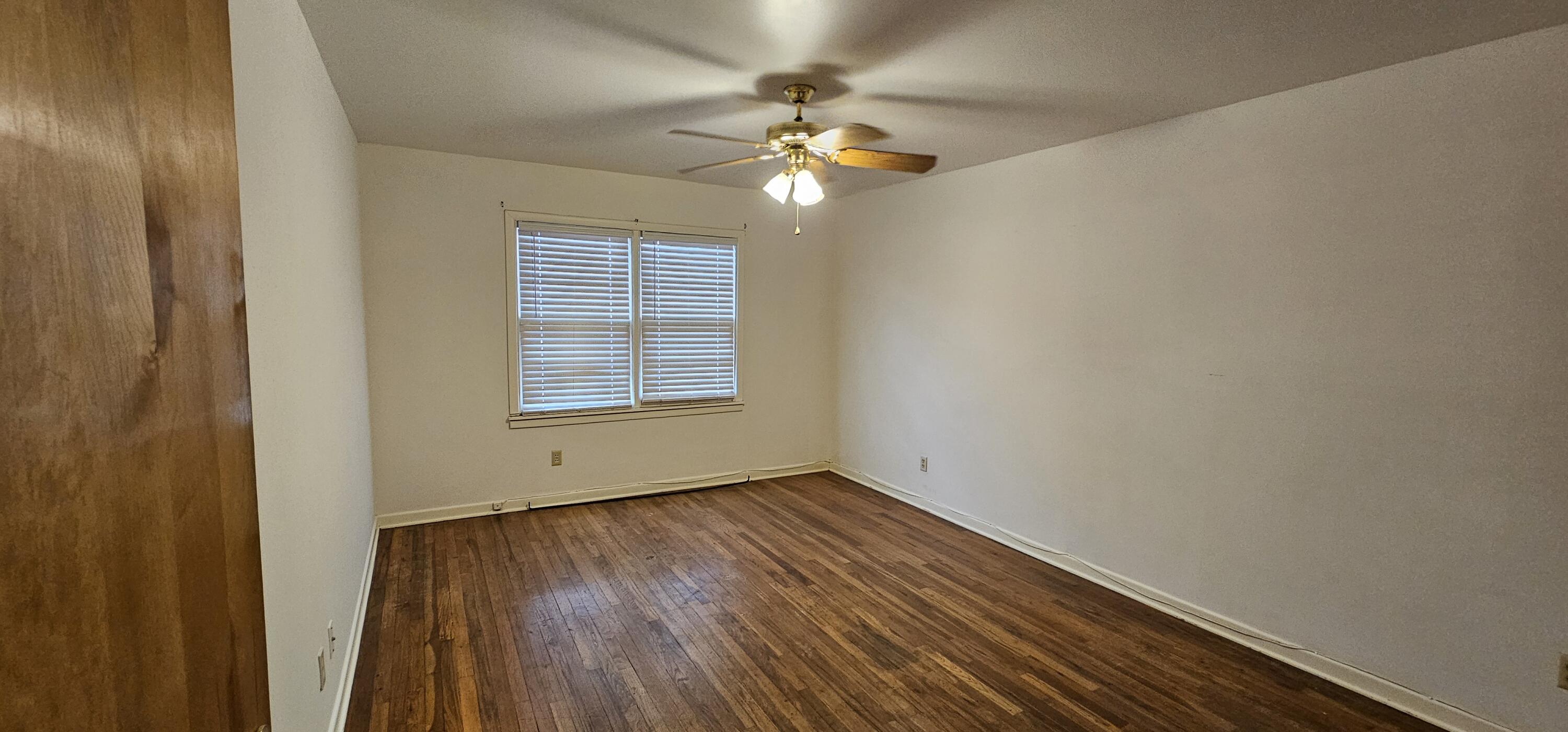 2007 62nd Street Lubbock, TX 79412 - Photo 6 of 17 a view of an empty room with wooden floor and a window
