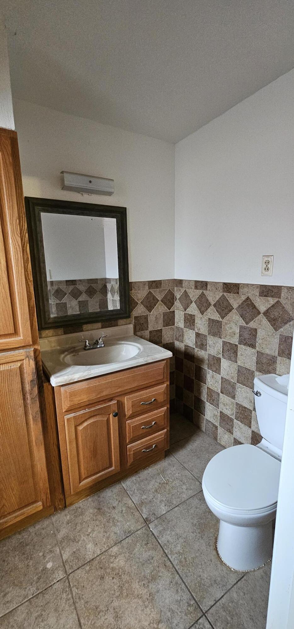 2007 62nd Street Lubbock, TX 79412 - Photo 8 of 17 a bathroom with a granite countertop toilet and a sink