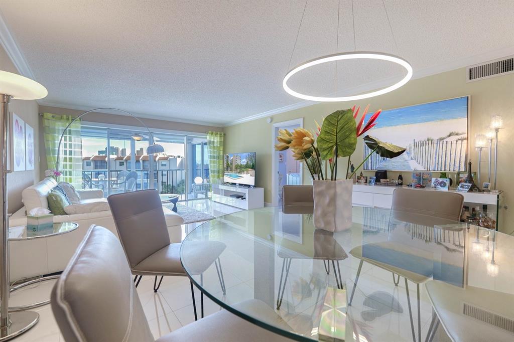 3930 Inverrary Boulevard, Unit 603D Lauderhill, FL 33319 - Photo 14 of 74 a dining room with furniture and a floor to ceiling window