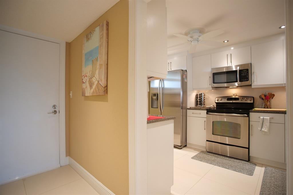 3930 Inverrary Boulevard, Unit 603D Lauderhill, FL 33319 - Photo 18 of 74 a kitchen with stainless steel appliances a refrigerator and a stove top oven