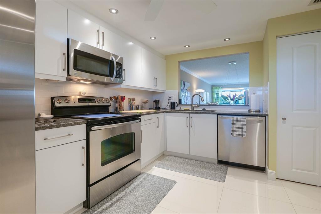 3930 Inverrary Boulevard, Unit 603D Lauderhill, FL 33319 - Photo 20 of 74 a kitchen with a sink stove and microwave
