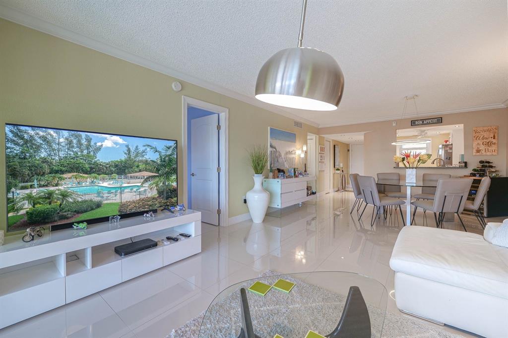 3930 Inverrary Boulevard, Unit 603D Lauderhill, FL 33319 - Photo 3 of 74 a living room with furniture a flat screen tv and a large window