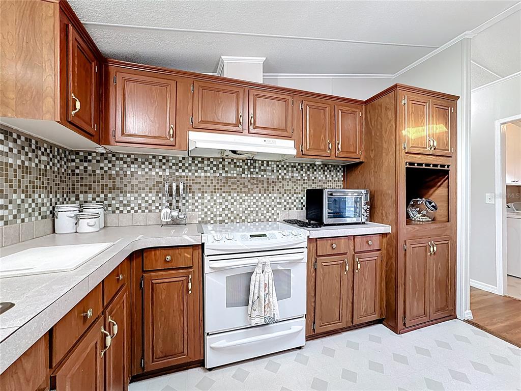4775 Cypress Creek Ranch Road St. Cloud, FL 34773 - Photo 17 of 63 a kitchen with stainless steel appliances granite countertop a sink stove and cabinets