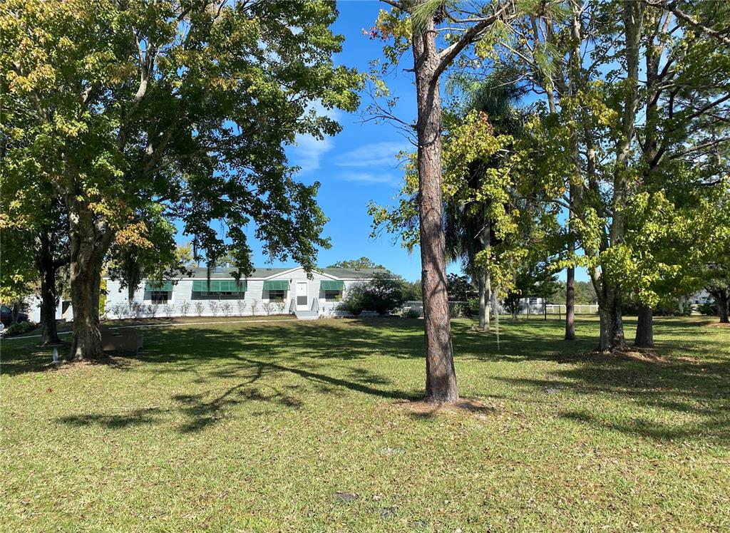 4775 Cypress Creek Ranch Road St. Cloud, FL 34773 - Photo 2 of 63 a view of a house with a yard