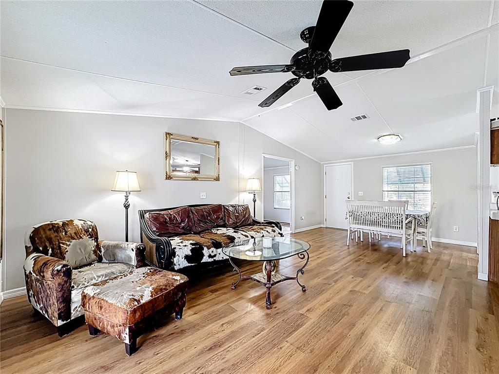 4775 Cypress Creek Ranch Road St. Cloud, FL 34773 - Photo 21 of 63 a living room with furniture and a wooden floor