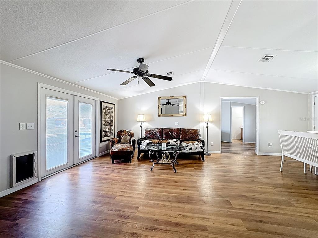 4775 Cypress Creek Ranch Road St. Cloud, FL 34773 - Photo 22 of 63 a living room with furniture and wooden floor