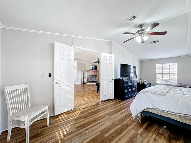 a view of a room with wooden floor