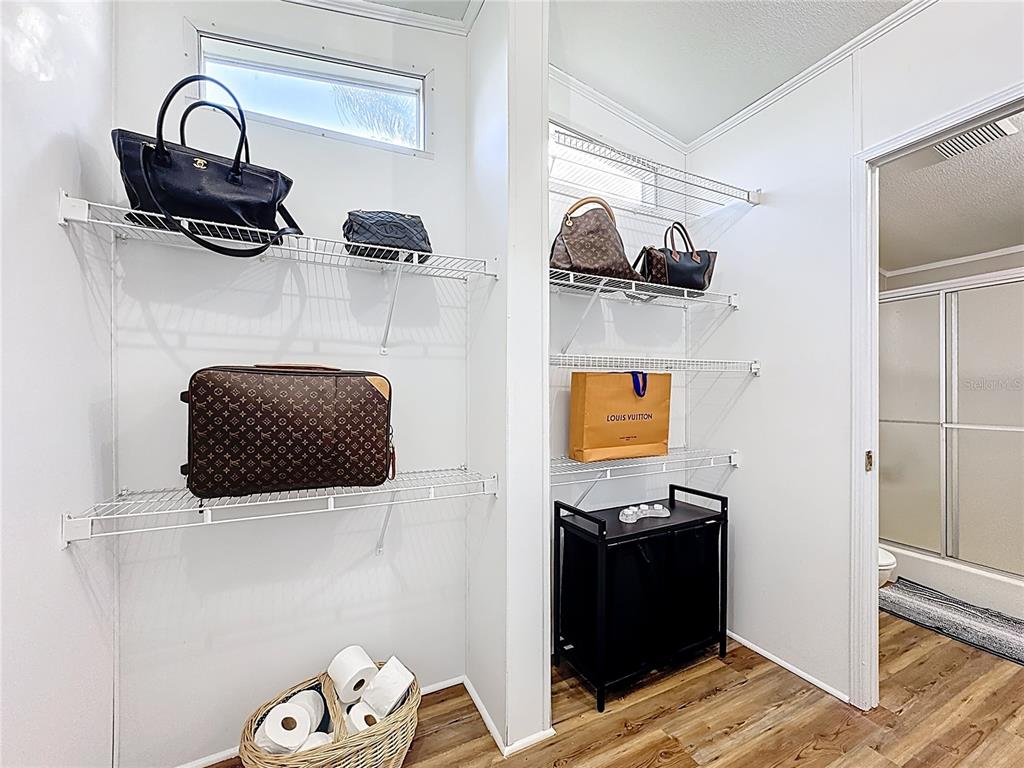 4775 Cypress Creek Ranch Road St. Cloud, FL 34773 - Photo 26 of 63 a view of walk in closet with clothes and shoes