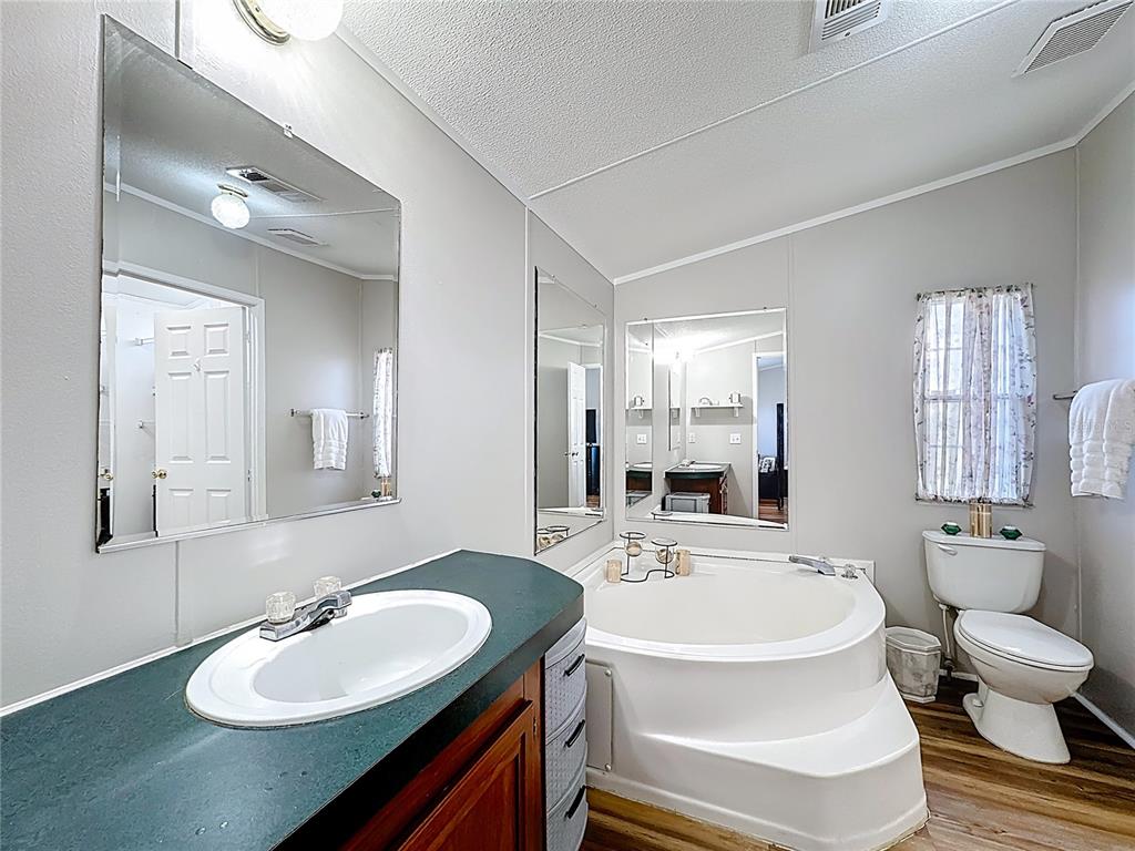 4775 Cypress Creek Ranch Road St. Cloud, FL 34773 - Photo 28 of 63 a bathroom with a sink and a mirror