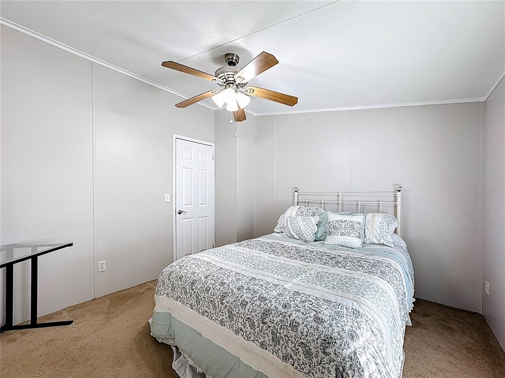 4775 Cypress Creek Ranch Road St. Cloud, FL 34773 - Photo 32 of 63 a bedroom with a bed and a ceiling fan
