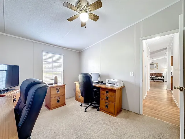 a view of a swimming pool with a bench and trees in the background