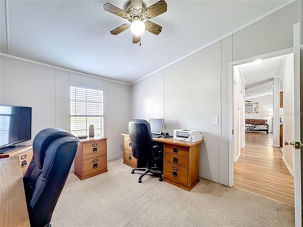 4775 Cypress Creek Ranch Road St. Cloud, FL 34773 - Photo 35 of 63 a view of a workspace with furniture and a window
