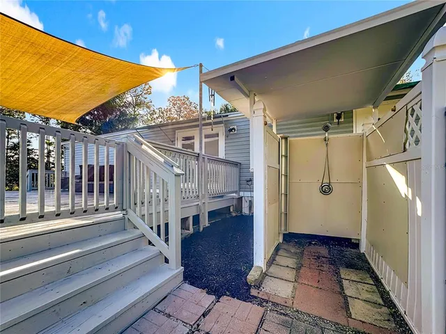 a view of a house with backyard and sitting area
