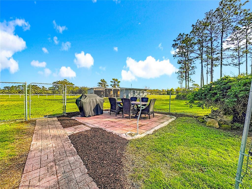 4775 Cypress Creek Ranch Road St. Cloud, FL 34773 - Photo 40 of 63 a view of a backyard with sitting space