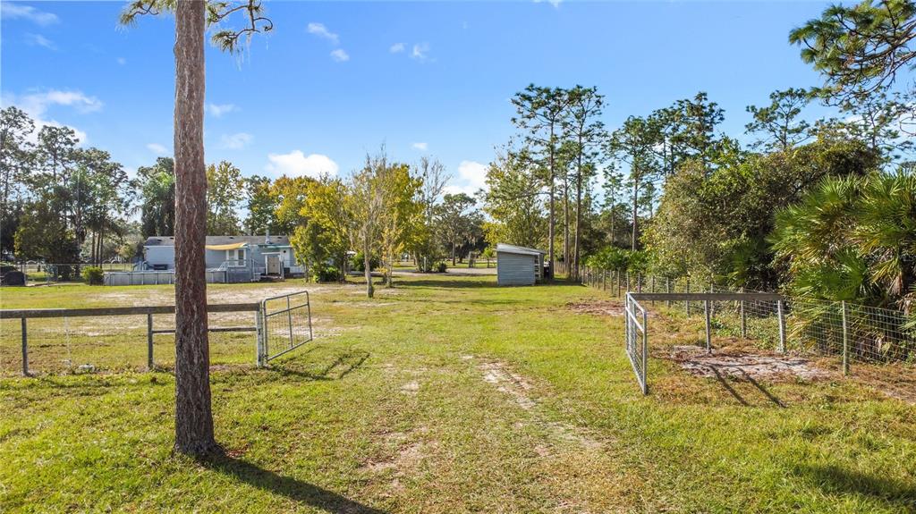 4775 Cypress Creek Ranch Road St. Cloud, FL 34773 - Photo 49 of 63 a view of a swimming pool with an outdoor seating and a yard