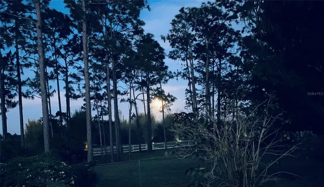 a living room with stainless steel appliances kitchen island granite countertop furniture and a fireplace