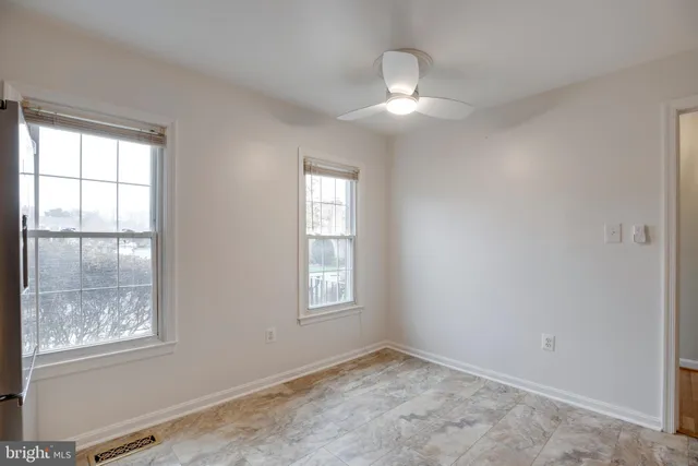 a view of a room with wooden floor and windows
