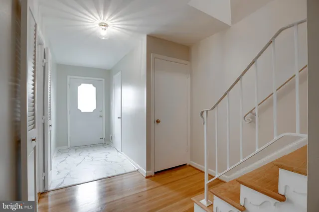 a view of entryway and hall with wooden floor