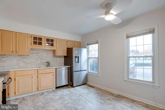 a kitchen with stainless steel appliances granite countertop a refrigerator stove top oven and sink