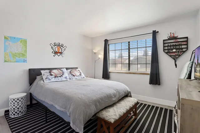 a bedroom with a bed and a desk in it