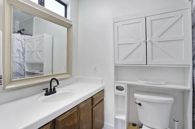 a bathroom with a toilet and a shower