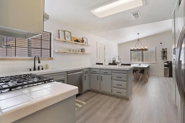 a kitchen with a stove a sink and a refrigerator