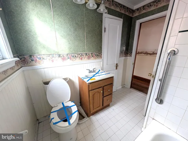 a bathroom with a sink mirror vanity and toilet