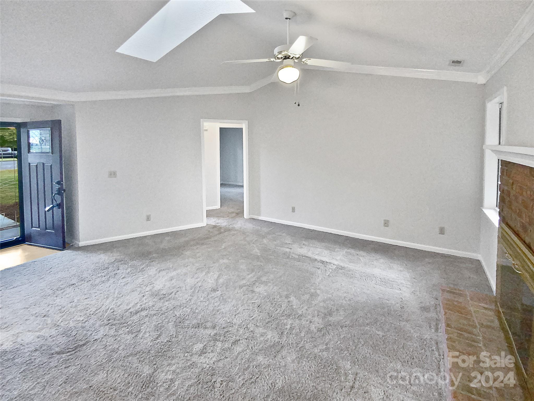 1150 Phillip Street Salisbury, NC 28147 - Photo 12 of 22 an empty room with a ceiling fan and a window