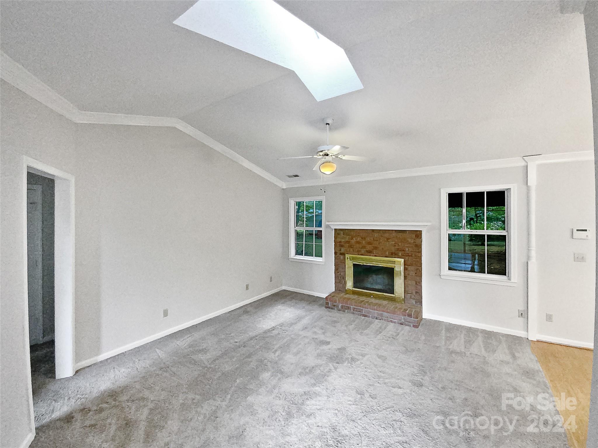 1150 Phillip Street Salisbury, NC 28147 - Photo 3 of 22 an empty room with a fireplace and windows
