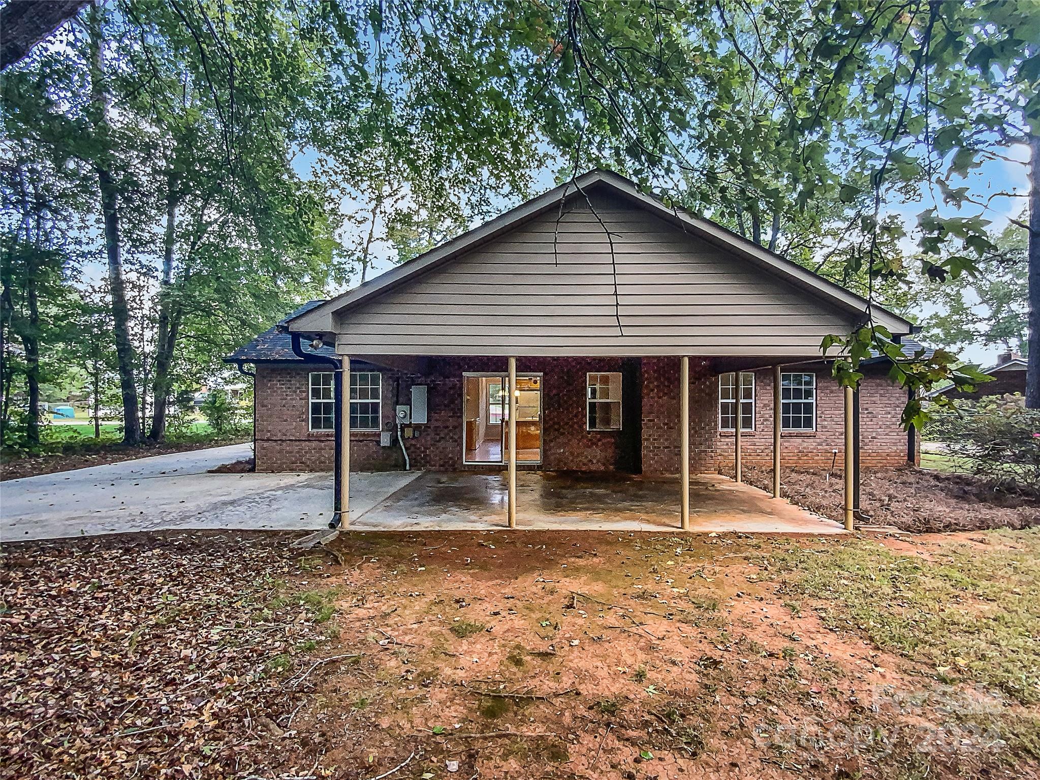 1150 Phillip Street Salisbury, NC 28147 - Photo 8 of 22 a house with lots of trees in the background