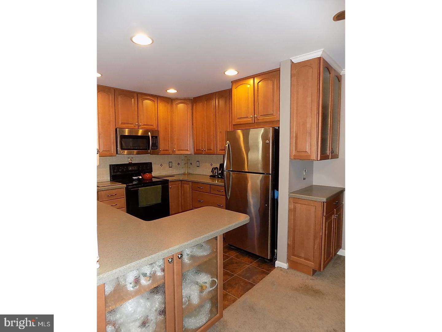 9 Circle Road Levittown, PA 19057 - Photo 9 of 22 a kitchen with stainless steel appliances a refrigerator and a microwave