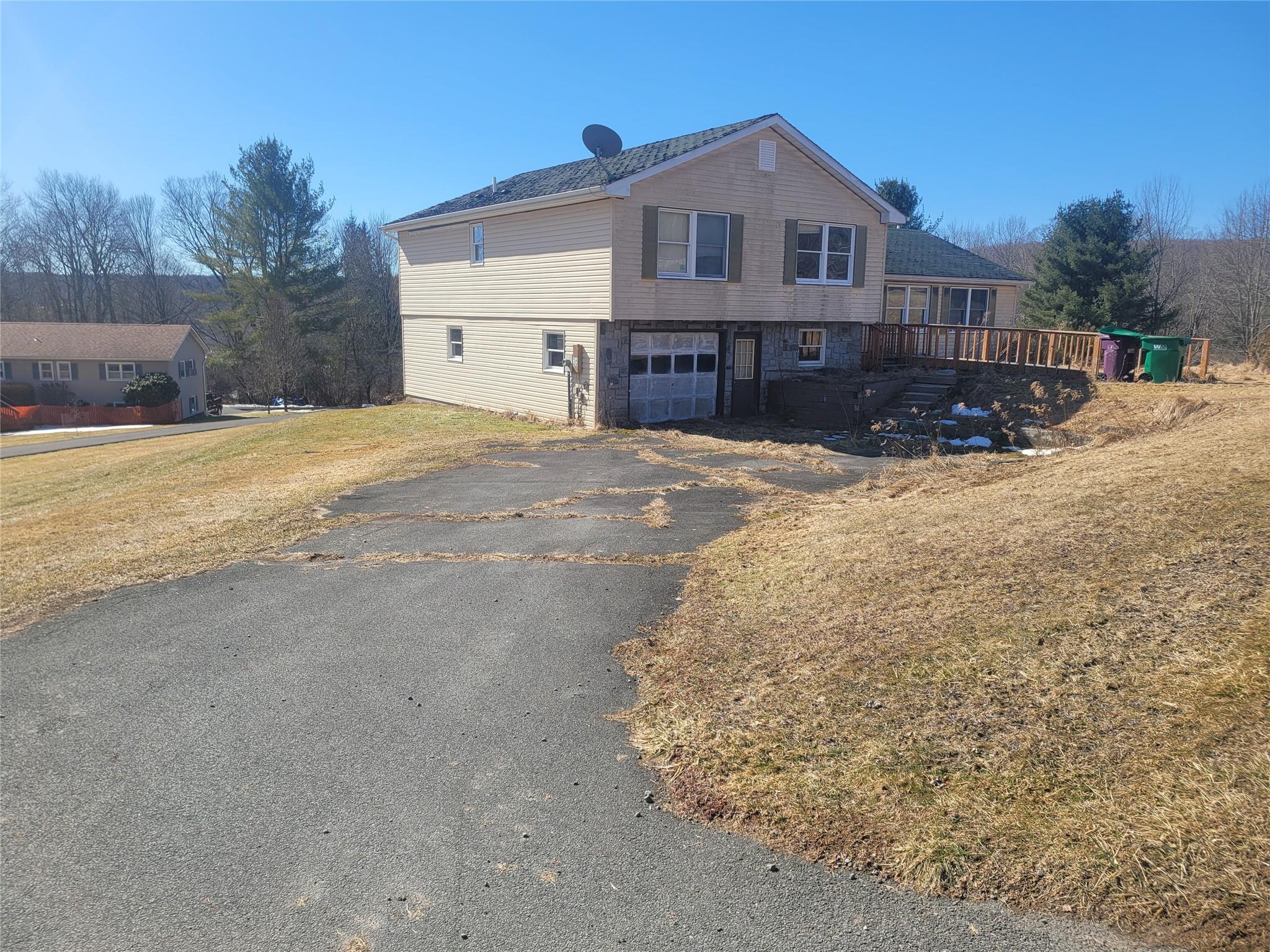 a front view of a house with a yard covered in snow
