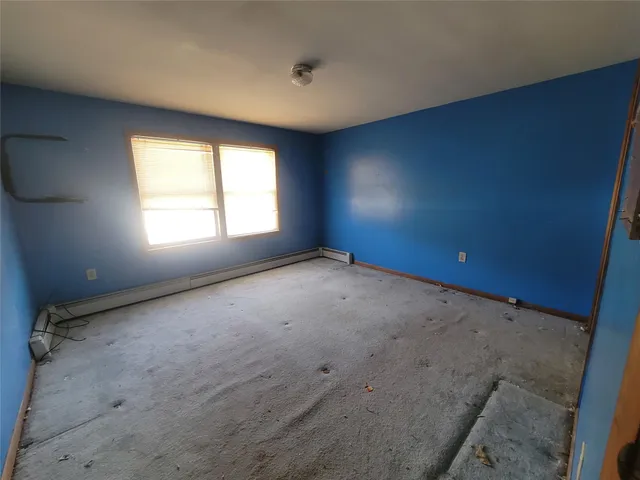 an empty room with a empty space and windows