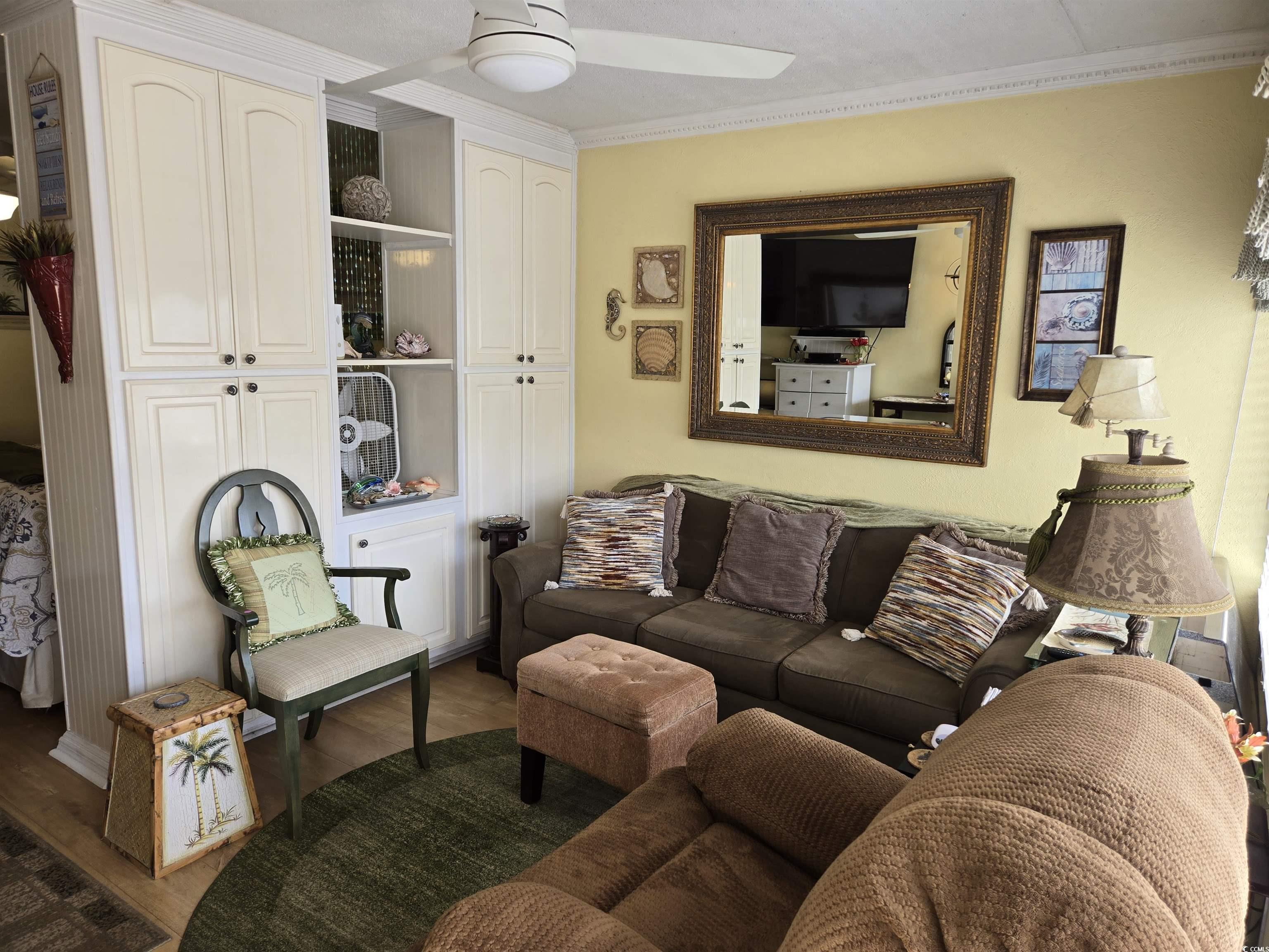 2204 Perrin Drive, Unit 3 North Myrtle Beach, SC 29582 - Photo 14 of 39 Living room featuring ornamental molding, ceiling fan, and wood-type flooring