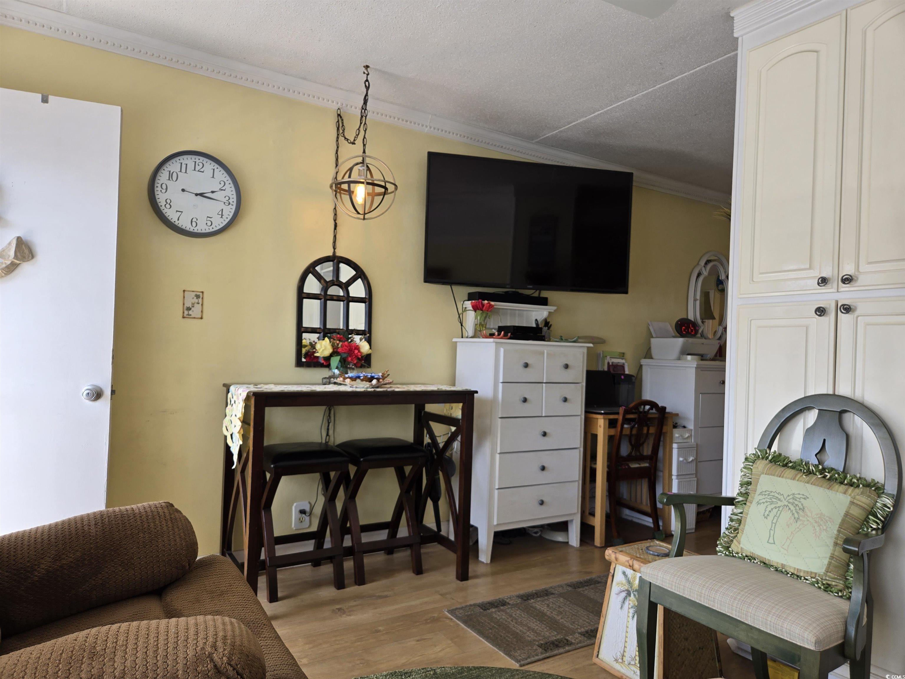 2204 Perrin Drive, Unit 3 North Myrtle Beach, SC 29582 - Photo 17 of 39 Living room with light hardwood / wood-style flooring and crown molding