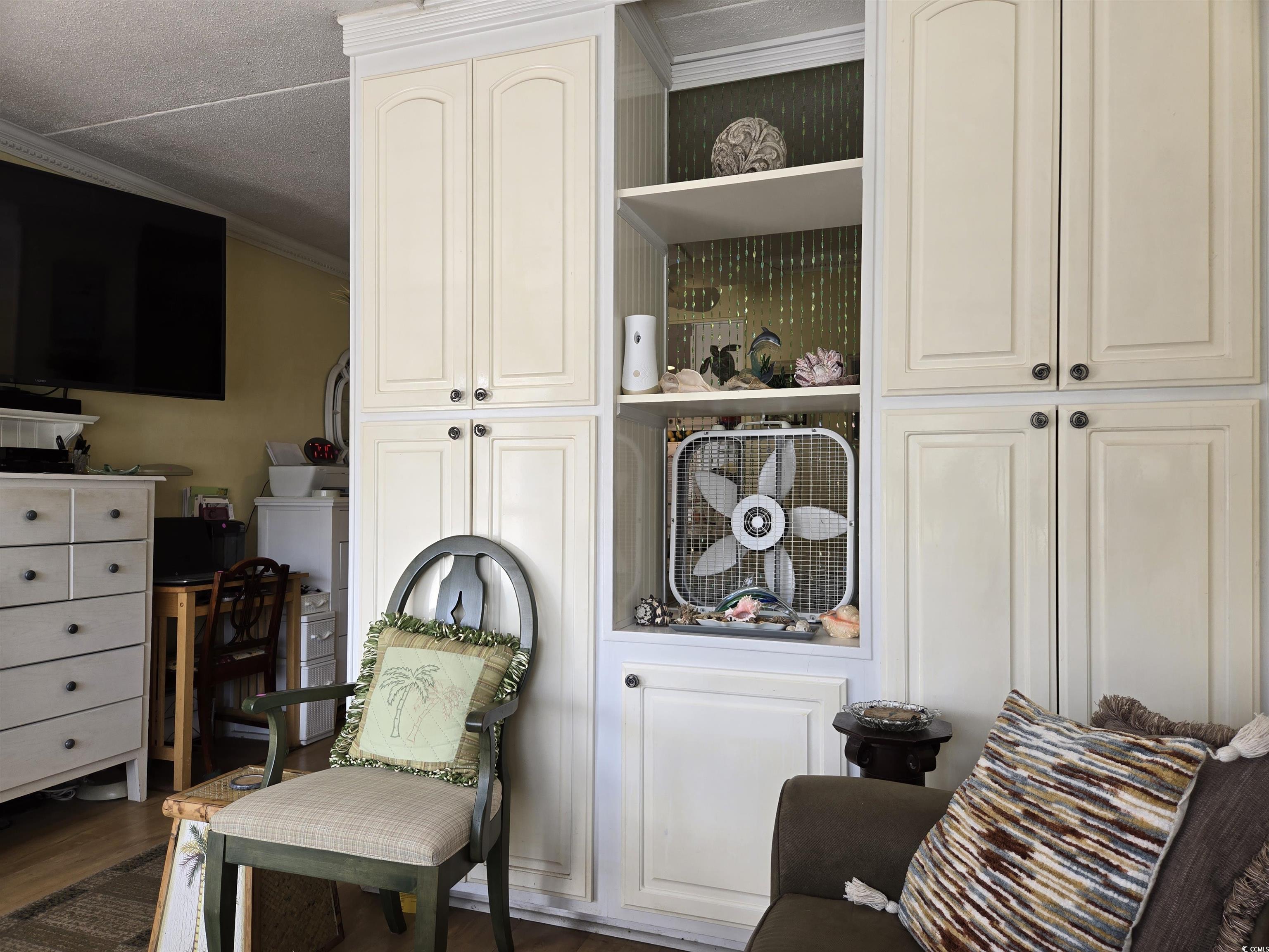 2204 Perrin Drive, Unit 3 North Myrtle Beach, SC 29582 - Photo 18 of 39 Sitting room featuring crown molding and dark hardwood / wood-style flooring