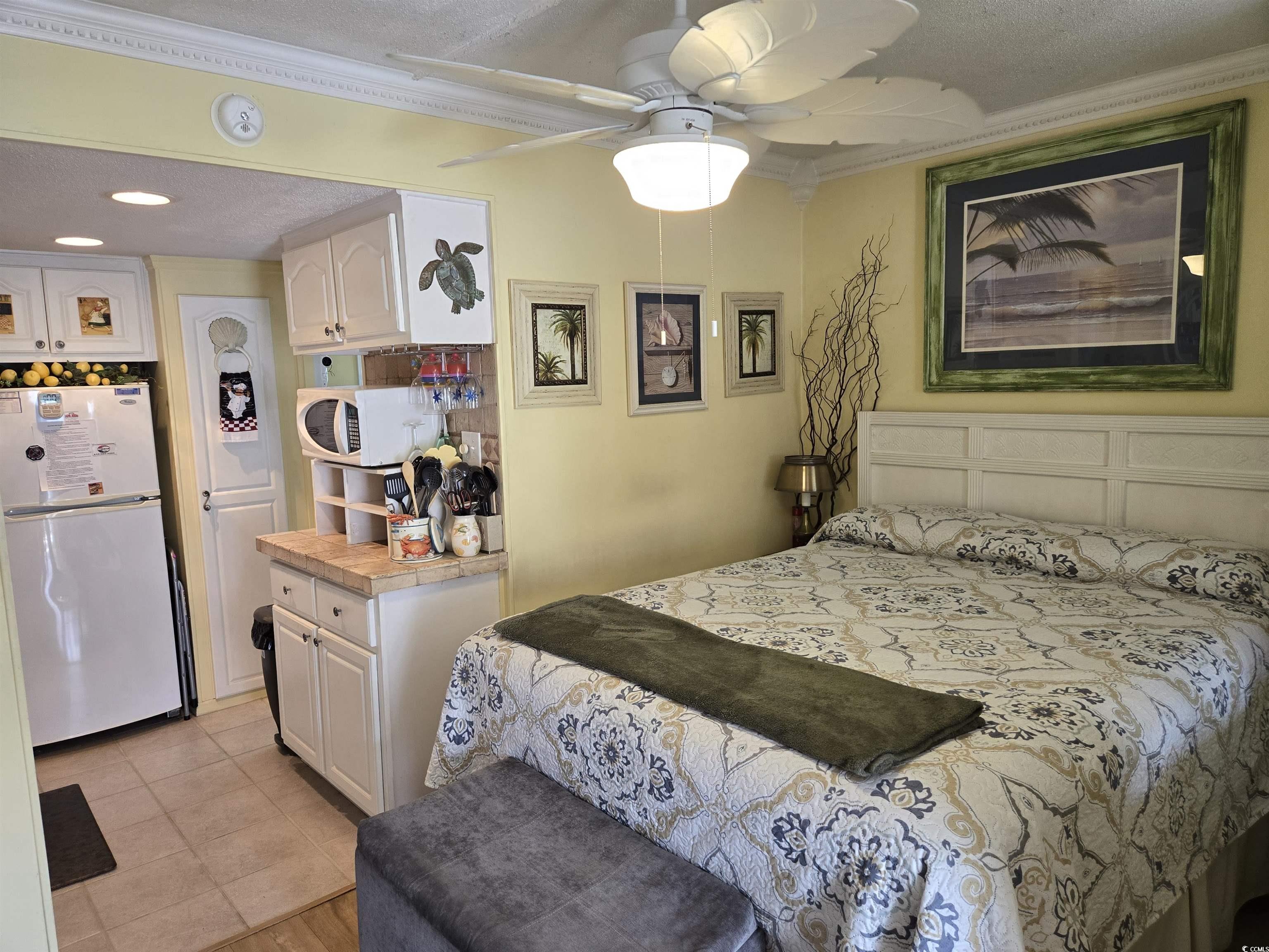 2204 Perrin Drive, Unit 3 North Myrtle Beach, SC 29582 - Photo 24 of 39 Tiled bedroom with a textured ceiling, ornamental molding, white refrigerator, and ceiling fan